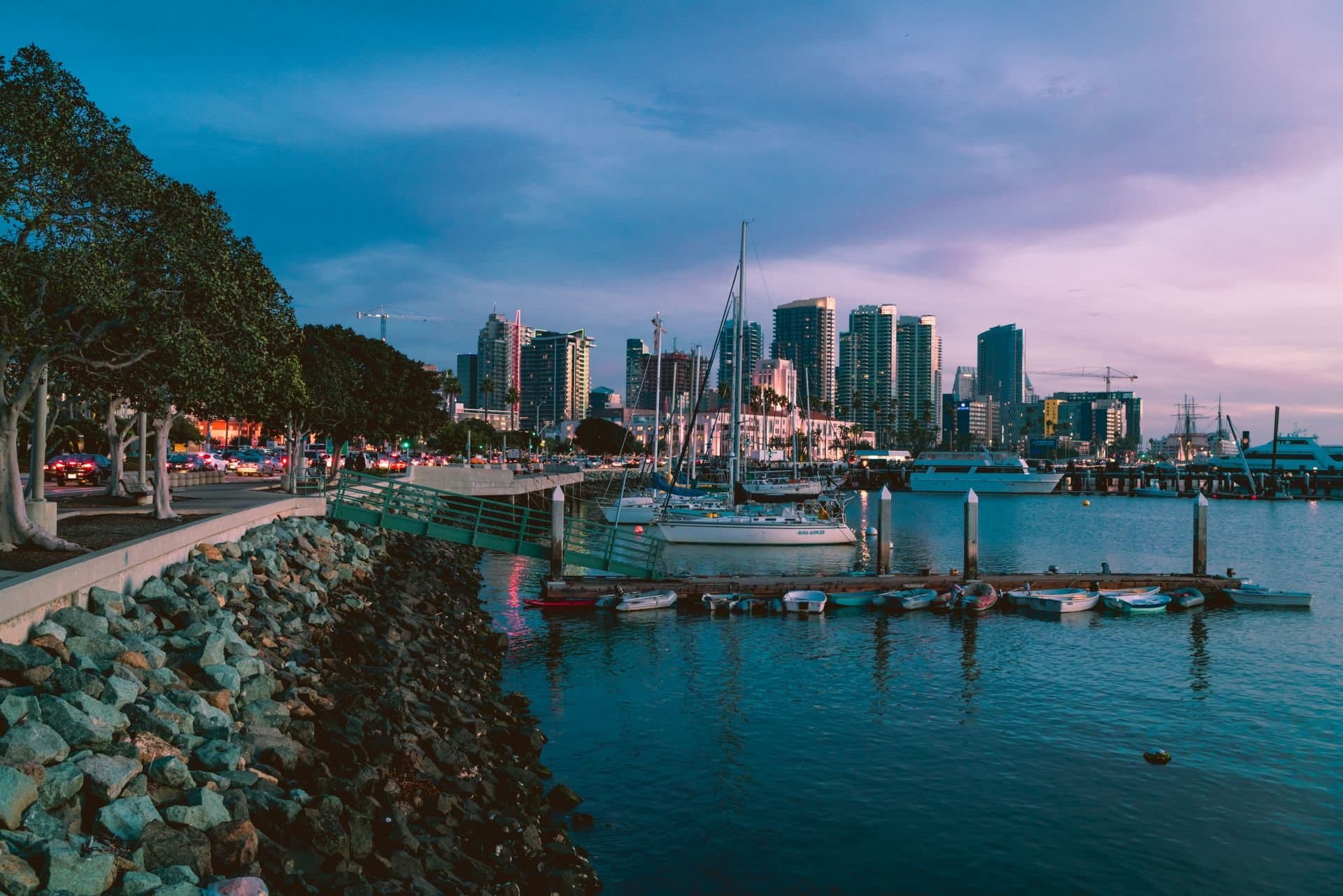 San Diego waterfront marina and skyline at dusk beside Little Italy