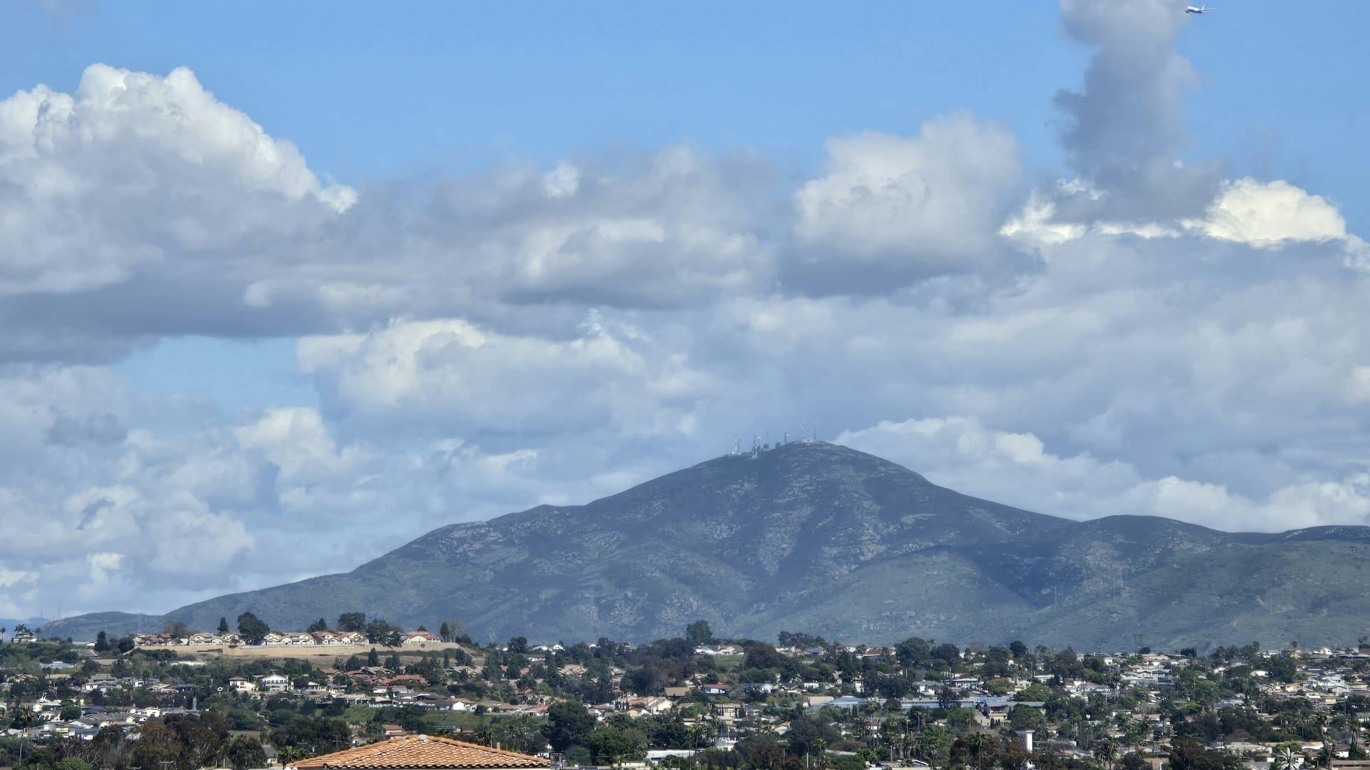 National City rooftops beneath a mountain backdrop