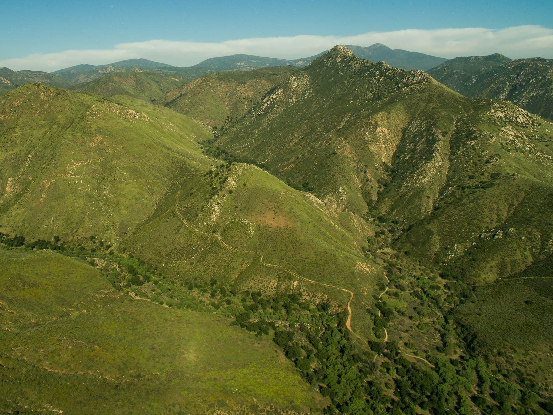 Green chaparral mountains on the Cedar Creek Falls trail near Ramona
