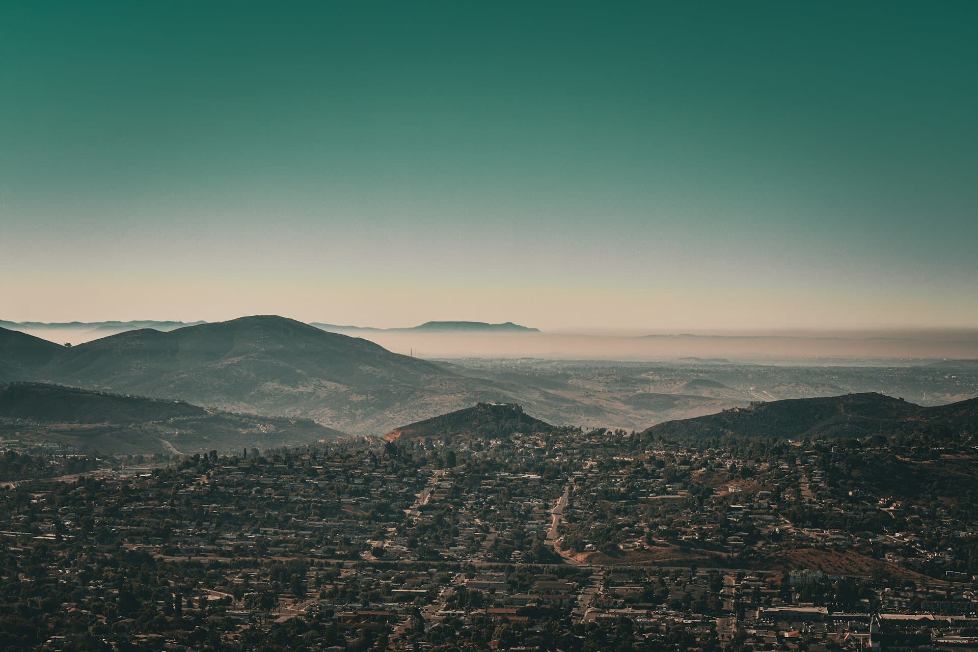 Homes filling an East County valley beneath layered ridges